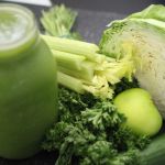 immune-enhancing green smoothie beside mixed veggies